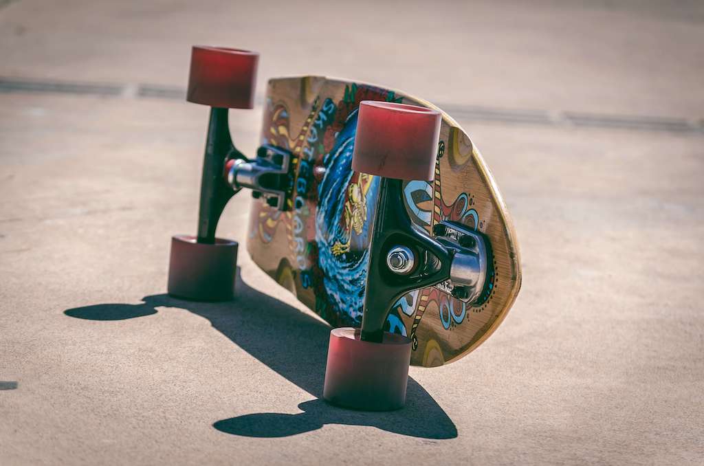 A skateboard laying on its side on top of concrete.